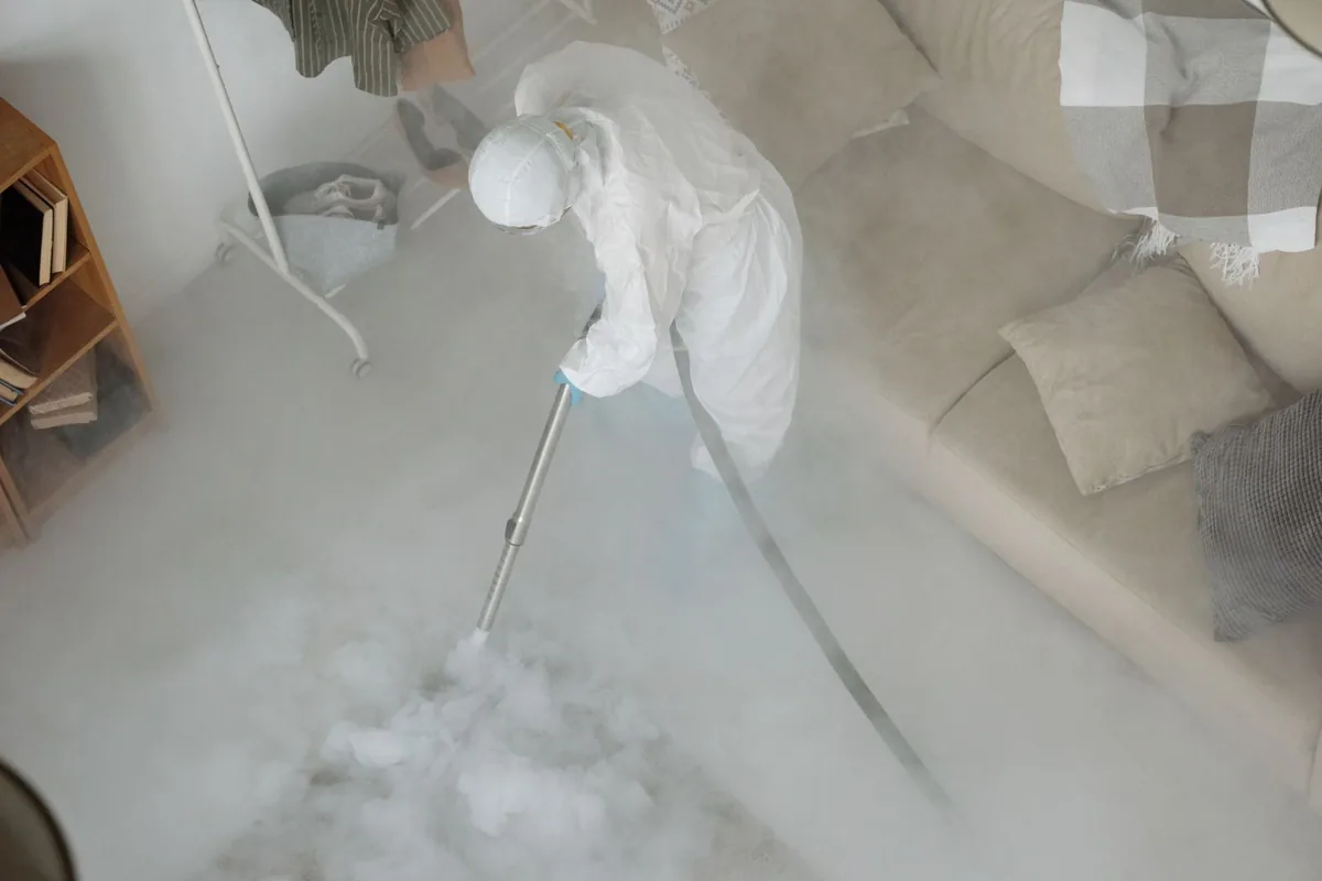 Biohazard cleanup technician in protective equipment, Warsaw, MO